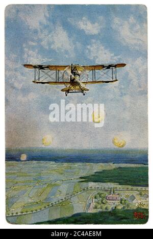 German historical postcard: German biplane with black crosses under fire from anti-aircraft artillery. Shell bursts, world war one 1914-1918. Germany Stock Photo