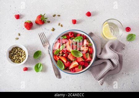 watermelon salad with strawberry raspberry basil seeds. healthy summer dessert Stock Photo