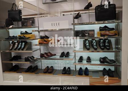 Dubai UAE December 2019 - Men shoes in a luxury store. Set of black and brown mens luxury shoes bags in the store. Mens footwear. Men elegant shoes in Stock Photo