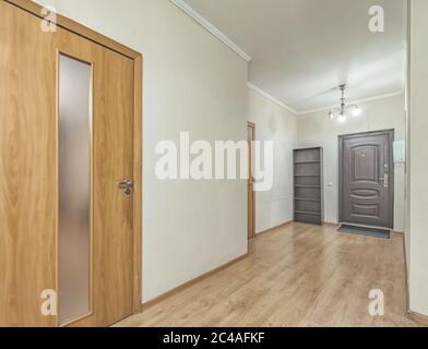 Empty residential house entrance with closed wooden doors tiny hallway Stock Photo