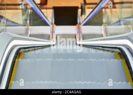 Escalator in shopping center. Close up escalators stairs up and down in office building, shopping mall or subway station. Stock Photo