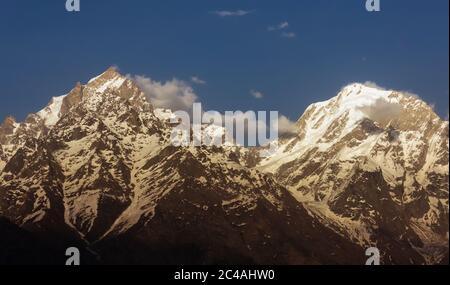 The snow covered peaks of the Kinner Kailash range in the village of Kalpa in Kinnaur in the Indian Himalaya. Stock Photo