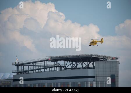 Glasgow, Scotland, UK. 25th June, 2020. Picture: Queen Elizabeth University Hospital (QEUH) helipad which is situated on the south west of the main building. Seen is the Scottish Air Ambulance Service transferring a patient. Credit: Colin Fisher/Alamy Live News Stock Photo