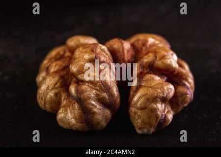 Walnut peeled close-up on dark background Stock Photo