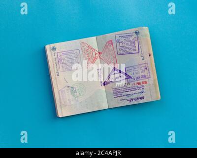 Open passport with several stamps from Thailand and Malaysia inside Stock Photo