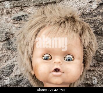 Old doll in abandoned house. Stock Photo