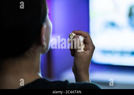 Woman Watching TV On Couch Or Sofa. Watch Television Stock Photo