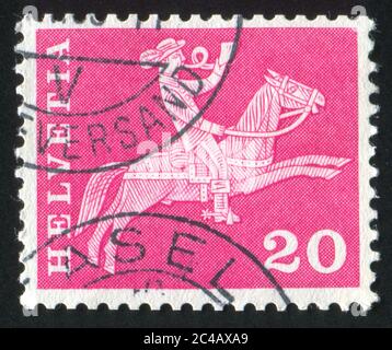 SWITZERLAND - CIRCA 1960: stamp printed by Switzerland, shows Postilion on horseback, circa 1960 Stock Photo