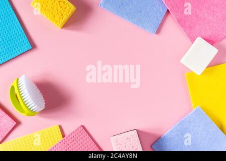 Multi-colored cloths and soap with brush on pink background , housekeeping and cleaning concept Stock Photo
