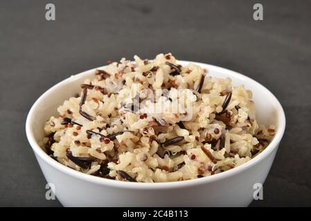 Blend of cooked tricolor quinoa, wild and brown rice in a bowl closeup Stock Photo