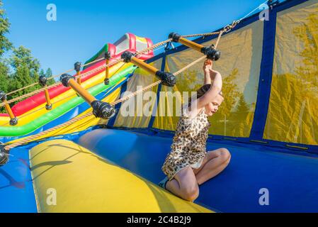 Girl enjoys twirly ladder attraction at Spring Fair, Stock Photo