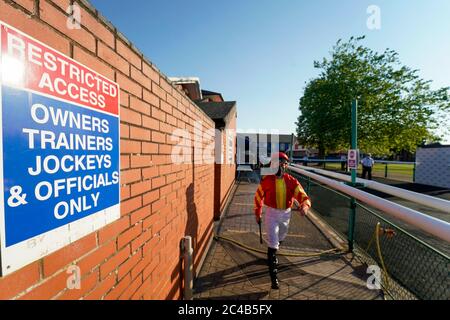 A general view as jockeys leave the weighing room and make their way to the parade ring at Leicester Racecourse.