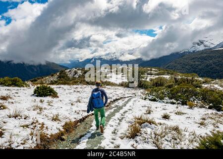Hiker on trail to Key Summit, Routeburn Track, Fiordland National Park, Te Anau, Southland, South Island, New Zealand Stock Photo