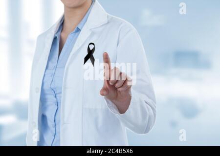 Mid section of lady doctor with black ribbon on robe touching digital screen Stock Photo