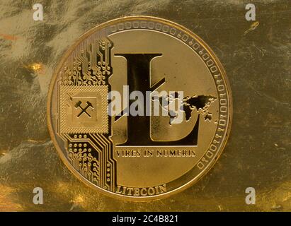Symbol image Cryptocurrency, digital currency, golden coin Litecoin with binary code, background image Stock Photo