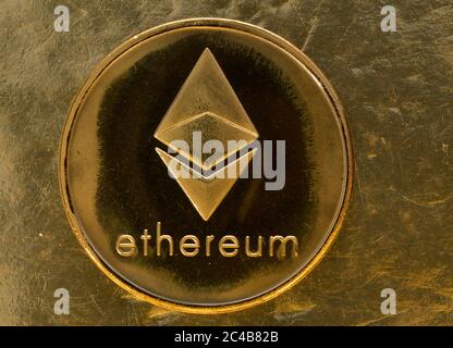 Symbol image Cryptocurrency, digital currency, golden coin Ethereum with binary code, background image Stock Photo