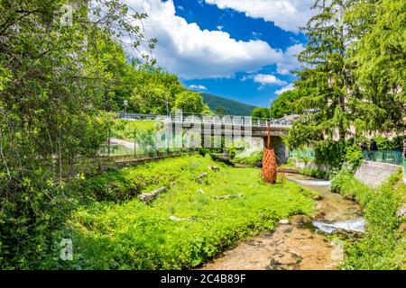 June 2, 2019 - Foligno, Umbria, Italy - The Menotre river runs through the small village of Rasiglia. A bridge crosses the river, the road passes over Stock Photo