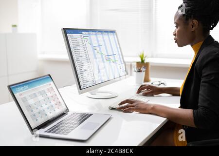 African Business Woman Using Corporate Gantt Chart On Computer Stock Photo
