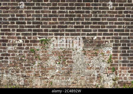 red brick wall background of old large weathered distressed brown stone Stock Photo