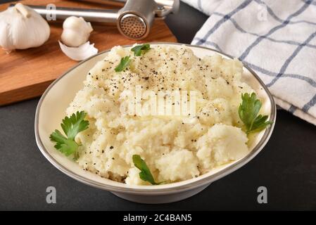 Bowl of hot garlic mashed potatoes with melting butter Stock Photo