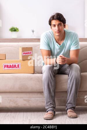 The man opening fragile parcel ordered from internet Stock Photo