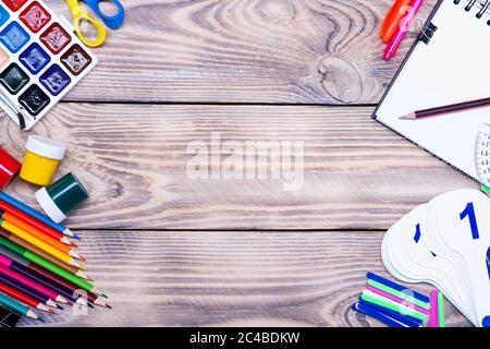School supplies on a wooden table with space for text, top view Stock Photo