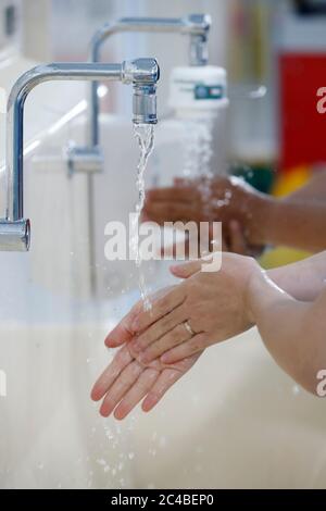 Nurse washing hands in medical aera Stock Photo