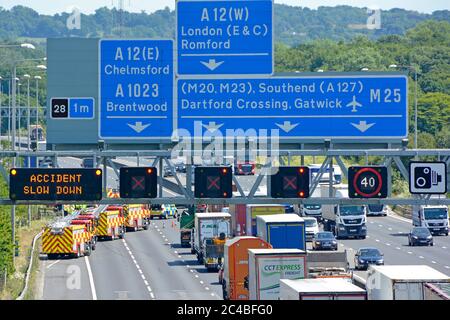 Motorway road sign close up & electronic digital information signs fire engine emergency services traffic accident closed three lanes M25 Brentwood UK Stock Photo
