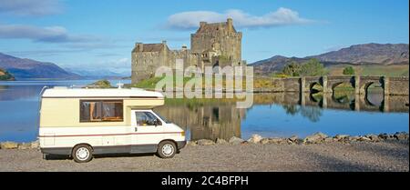 Eilean Donan Castle VW Volkswagen RV Auto Sleeper camper van motorhome early morning beside reflections on Loch Duich Scottish Highlands Scotland UK