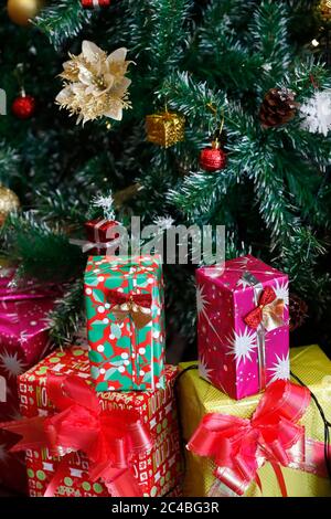 Presents under the decorated artificial christmas tree Stock Photo