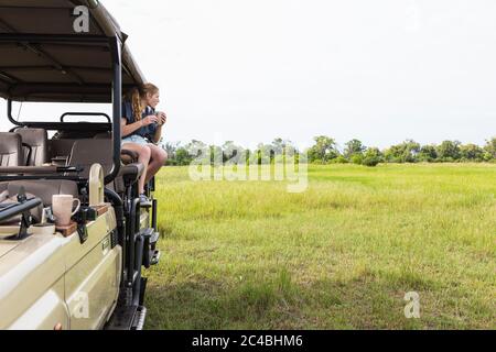 13 year old girl on safari vehicle, Botswana Stock Photo