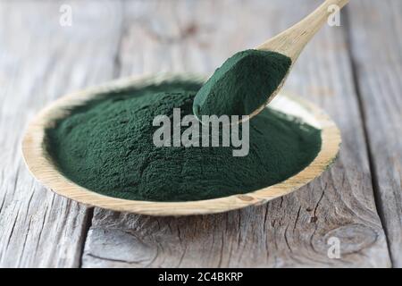 Chlorella single celled green algae. Detox superfood on the wooden plate Stock Photo