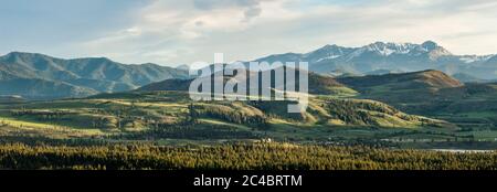 A panorama view from Studhorse Mountain road in Winthrop, Washington looking south, southwest at sunset. Stock Photo