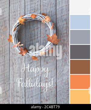 Color matching palette from picture of wattle wreath with dry orange and yellow Autumn leaves on grey aged wood Stock Photo