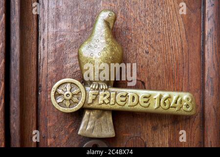 door handle in form of a dove with lettering Friede 1648, Peace of Westphalia on the town hall, Germany, Lower Saxony, Osnabrueck Stock Photo
