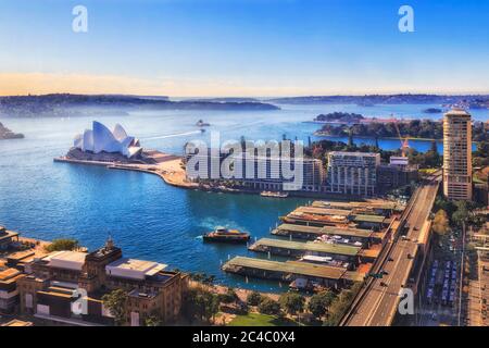 Circular quay ferry wharves and major city landmars in Sydney from elevation of nearby high-rise towers. Stock Photo
