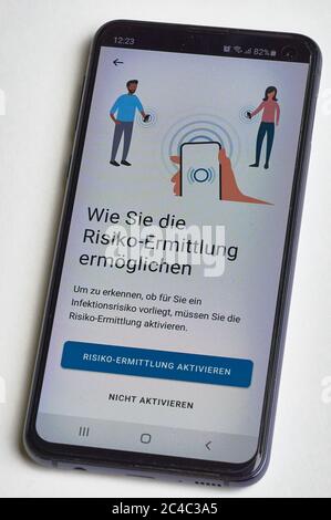 Risk assessment with the Corona Warn app. Smartphone app to combat the corona pandemic in Germany. Stock Photo