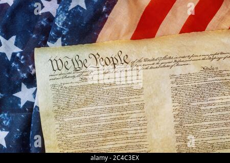 Closeup of a replica of U.S. Constitution document of grunge American flag on We the people Bill of Rights Stock Photo