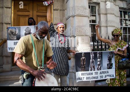 London, UK. 25th June, 2020. A protester playing a drum during the demonstration.Protesters from the ‘Africans in the Diaspora' gather outside Christie's to demand the return of African Artifacts. Europe's museums are fighting to keep Africa's artifacts as pressure mounts from campaigners. Credit: SOPA Images Limited/Alamy Live News Stock Photo