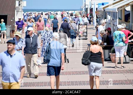 Sylt, Germany. 23rd June, 2020. Visitors walk along the promenade of Westerland. (to dpa 'The people are euphoric' - holiday on Sylt in times of Corona') Credit: Carsten Rehder/dpa/Alamy Live News Stock Photo