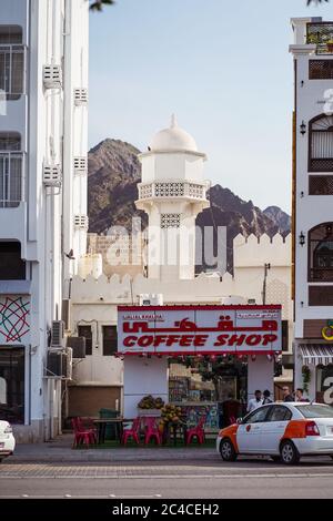 Muscat / Oman - February 15, 2020: small coffee shop in Mutrah Souq with beautiful white mosque minaret in background behind Stock Photo