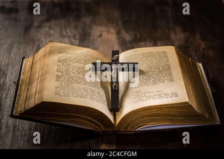 Open old bible with crucifix in vintage style Stock Photo
