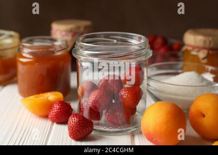 Composition with jam on white wooden table. Preparing jam Stock Photo