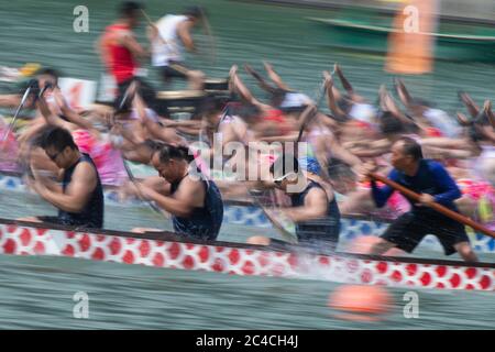 Beijing, China. 25th June, 2020. Dragon boat crew members participate in a traditional Chinese dragon boat race in Macao, south China, June 25, 2020. The Dragon Boat Festival, also called the Duanwu Festival, is traditionally celebrated on the fifth day of the fifth month on Chinese lunar calendar. It falls on June 25 this year. Credit: Cheong Kam Ka/Xinhua/Alamy Live News Stock Photo