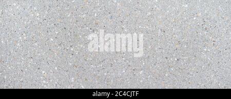 Bright, smooth concrete slab with pattern of colored stones Stock Photo