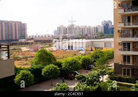 Photograph taken from a balcony showing multiple buildings and construction site in the distance on the horizon Stock Photo
