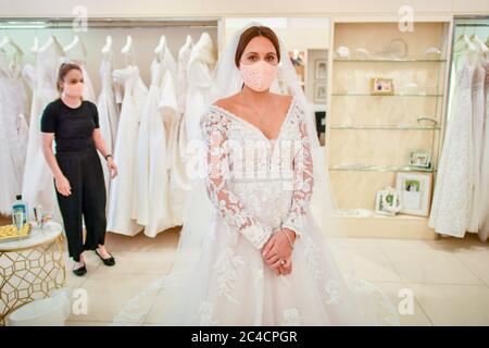 Face coverings are worn by bride to be Jessica Letheren and bridal consultant Felicity Gray during a dress fitting appointment at Allison Jayne Bridalwear in Clifton, Bristol, which has reopened following the lifting of coronavirus lockdown restrictions, with measures put in place to prevent the spread of coronavirus during brides' dress fittings. Stock Photo