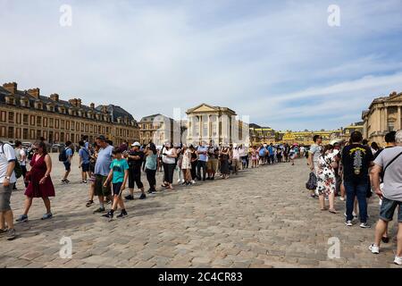 Versailles, France - August 27, 2019 : People visiting the Palace of Versailles, a royal chateau in Versailles, France. Marble Court. It was added to Stock Photo