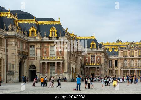 Versailles, France - August 27, 2019 : People visiting the Palace of Versailles, a royal chateau in Versailles, France. Marble Court. It was added to Stock Photo