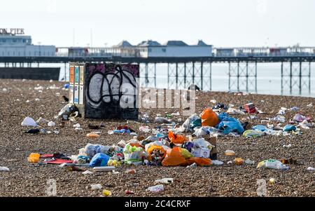 Brighton UK 26th June 2020 - Piles of litter on Brighton beach and seafront this morning which has been left behind by the crowds of visitors yesterday which was the hottest day of the year so far  : Credit Simon Dack / Alamy Live News Stock Photo